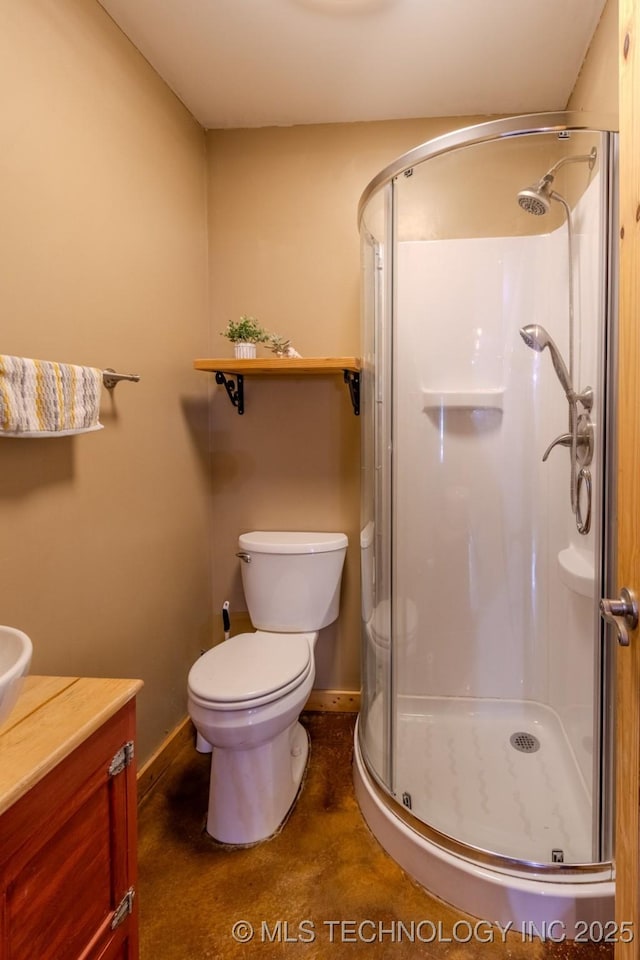 bathroom with an enclosed shower, vanity, and toilet