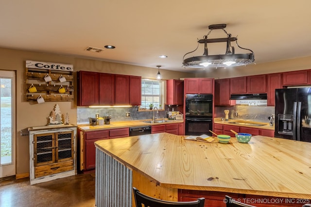 kitchen with wooden counters, ventilation hood, sink, and black appliances