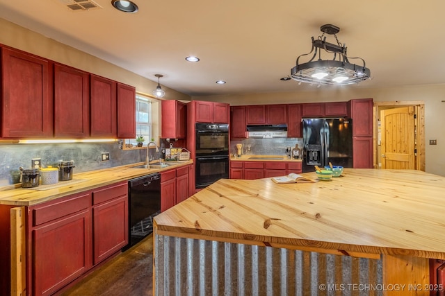 kitchen with hanging light fixtures, sink, wood counters, and black appliances