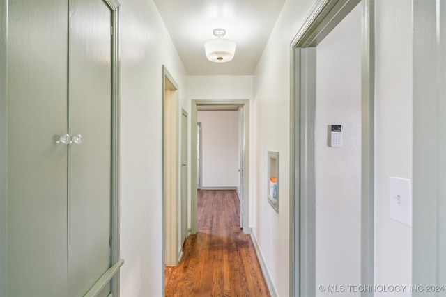 corridor with dark wood-type flooring