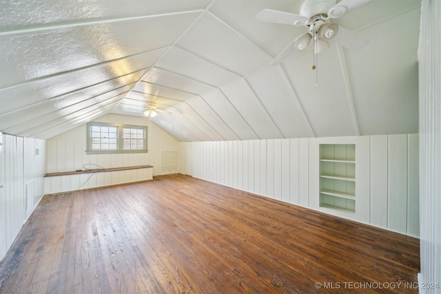 additional living space featuring lofted ceiling, ceiling fan, built in features, and dark hardwood / wood-style floors