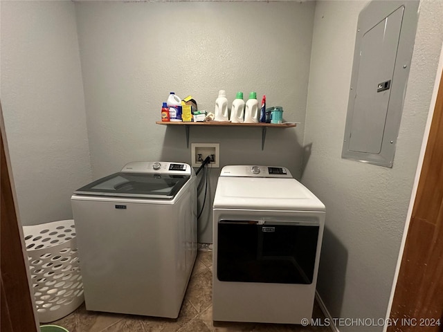 washroom with electric panel, separate washer and dryer, and light tile patterned floors