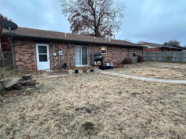 rear view of property with cooling unit