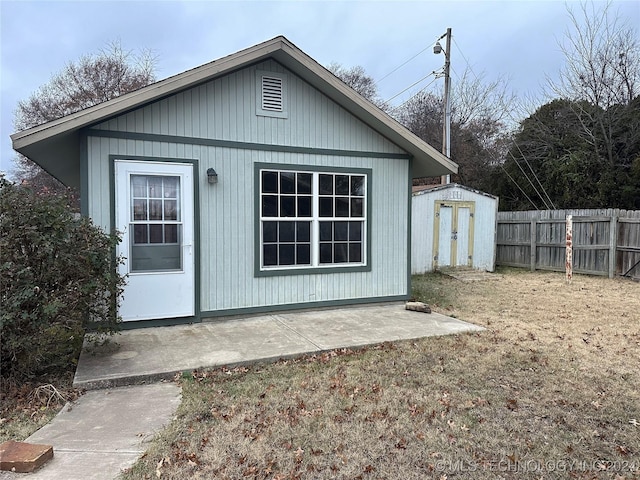 exterior space with a storage shed and a yard