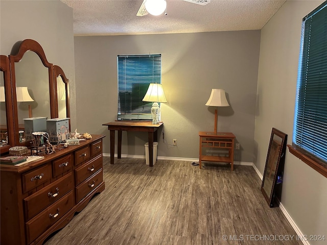 sitting room with ceiling fan, a textured ceiling, and hardwood / wood-style flooring