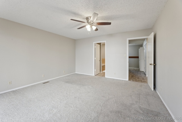 unfurnished bedroom with visible vents, a textured ceiling, baseboards, and carpet floors