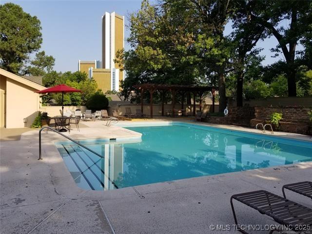 pool featuring a patio and fence