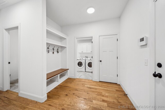 mudroom with washing machine and dryer and wood-type flooring