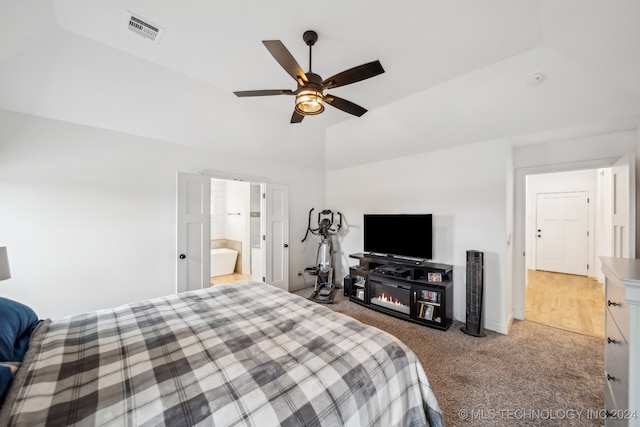 bedroom featuring carpet flooring, ensuite bath, ceiling fan, and lofted ceiling