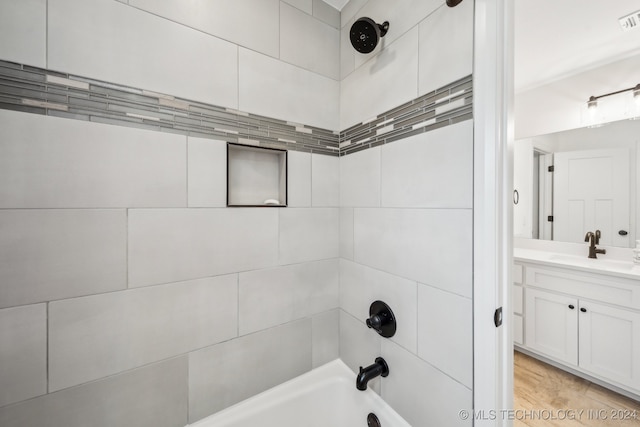 bathroom featuring vanity and tiled shower / bath combo