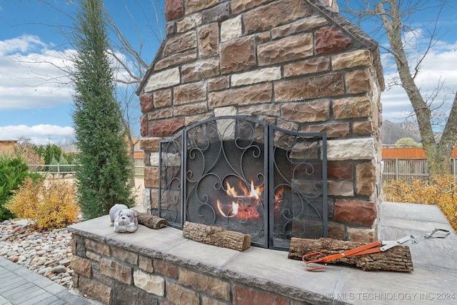 details featuring an outdoor stone fireplace