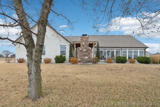 back of property featuring a lawn