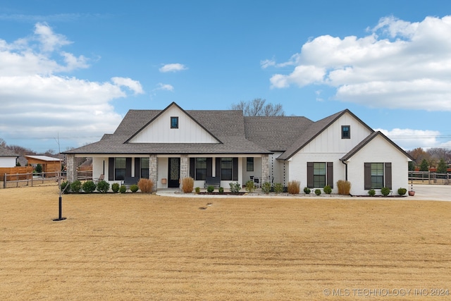 view of front of home with a porch and a front lawn