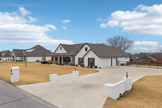 view of front of home featuring a garage and a front lawn