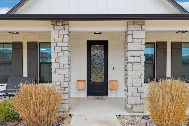 view of exterior entry with a porch