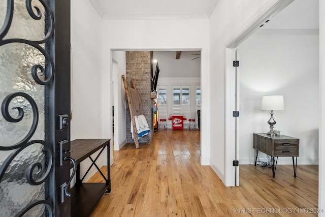 foyer entrance featuring light hardwood / wood-style floors and ornamental molding