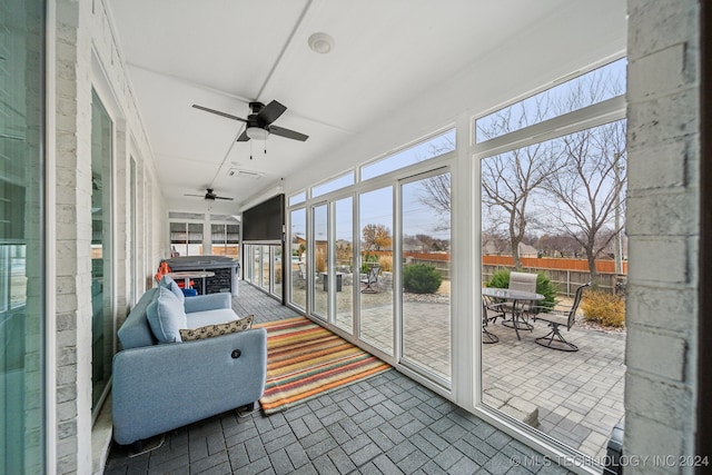 sunroom featuring ceiling fan and a healthy amount of sunlight