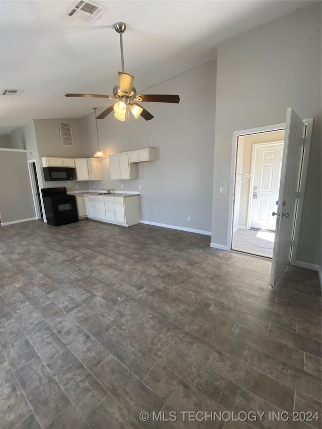 unfurnished living room with high vaulted ceiling and ceiling fan