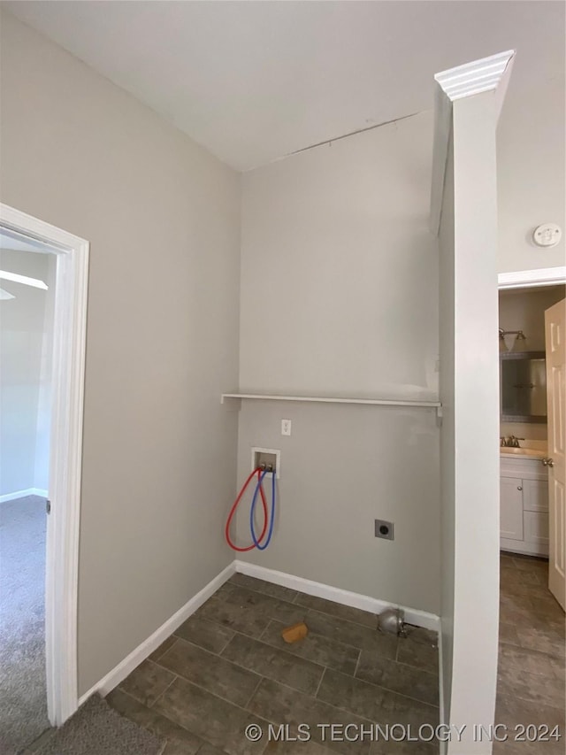 laundry area featuring hookup for an electric dryer, hookup for a washing machine, and sink