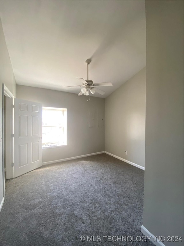 carpeted spare room with ceiling fan