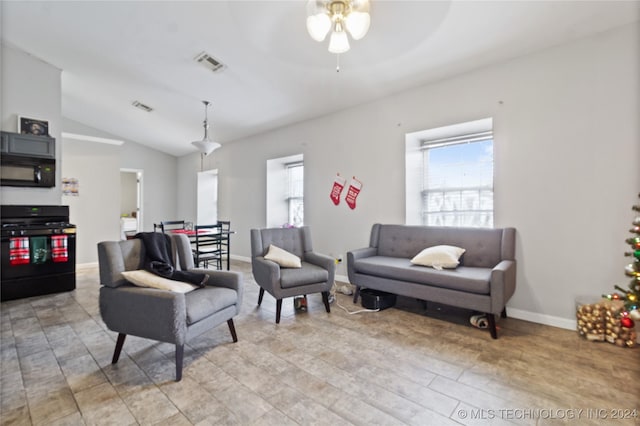 living room with ceiling fan, light wood-type flooring, and vaulted ceiling