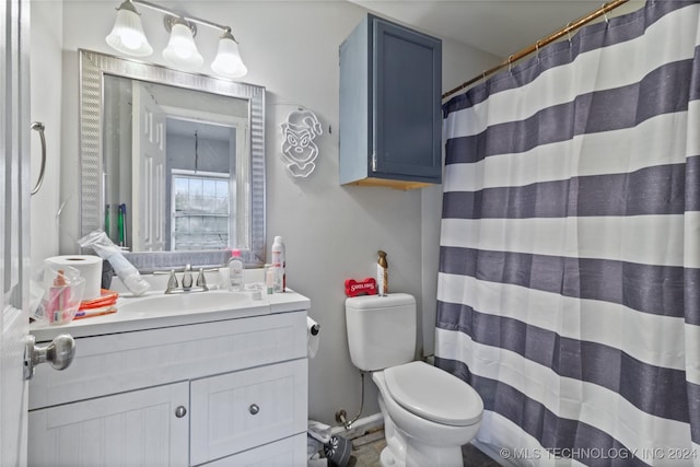 bathroom featuring vanity, a shower with shower curtain, and toilet