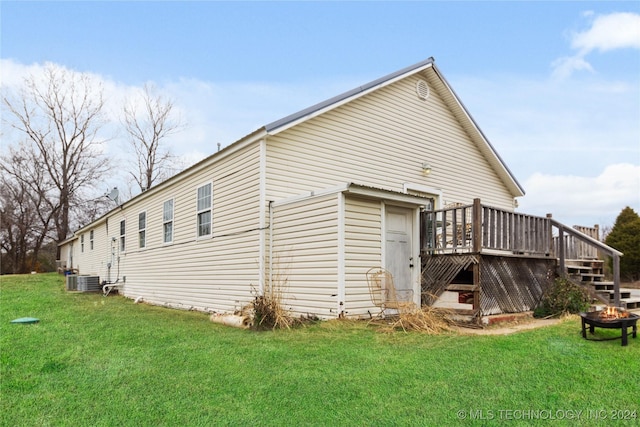 rear view of property with a lawn and a deck