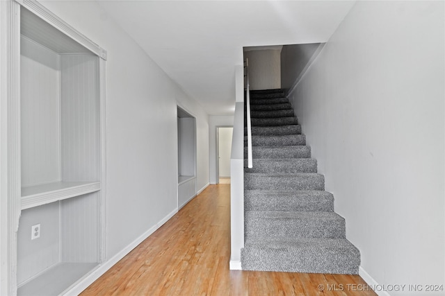 staircase featuring hardwood / wood-style flooring