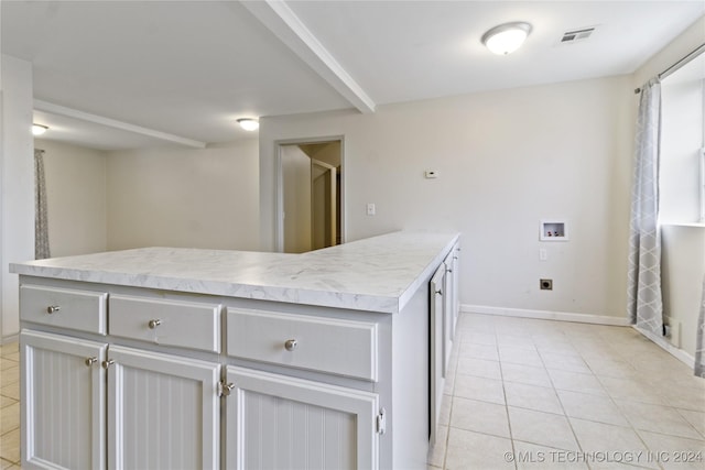 kitchen with light tile patterned floors and a kitchen island