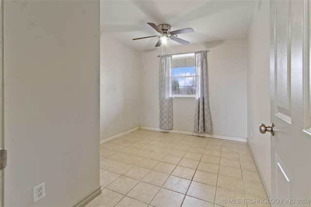 spare room featuring ceiling fan and light tile patterned floors