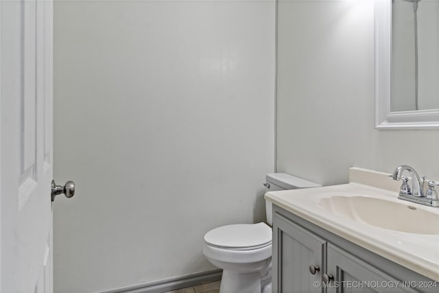 bathroom featuring tile patterned floors, vanity, and toilet