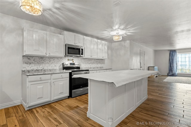 kitchen with light wood-type flooring, white cabinetry, and stainless steel appliances