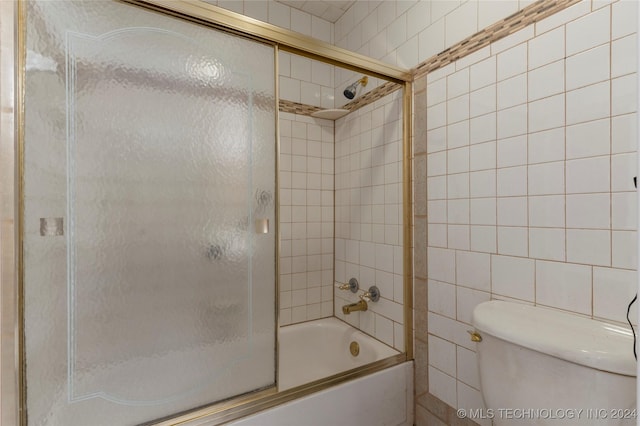 bathroom with toilet and enclosed tub / shower combo