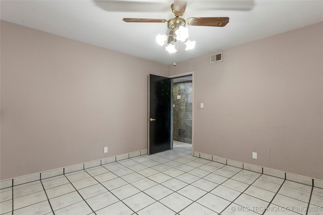 tiled spare room with ceiling fan