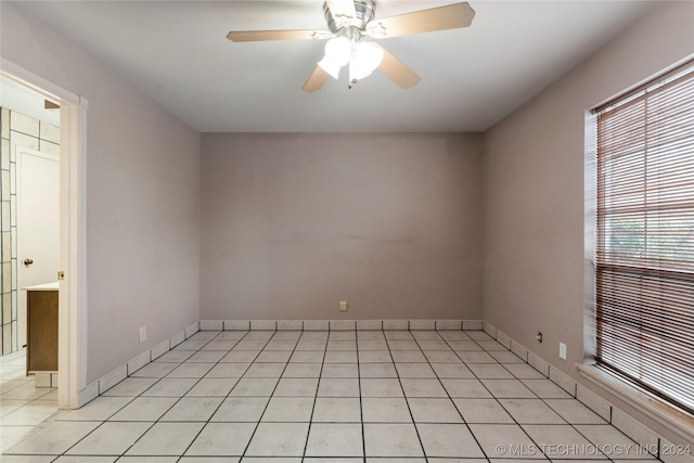 spare room with light tile patterned floors and ceiling fan