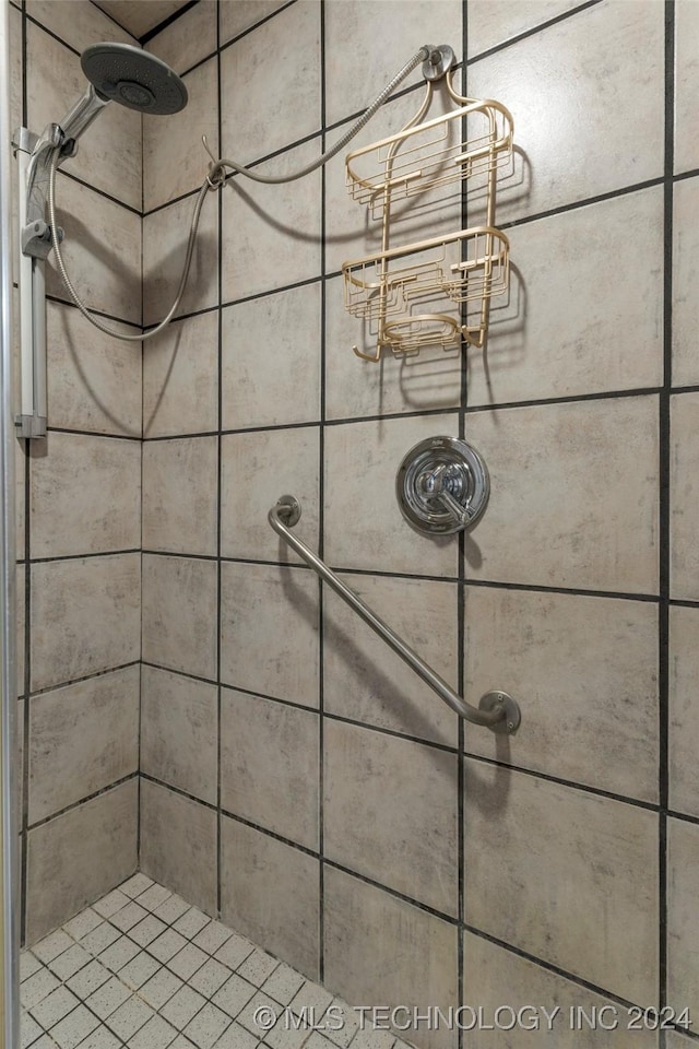 interior details featuring tiled shower