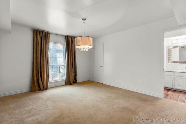 unfurnished room featuring light wood-type flooring and sink