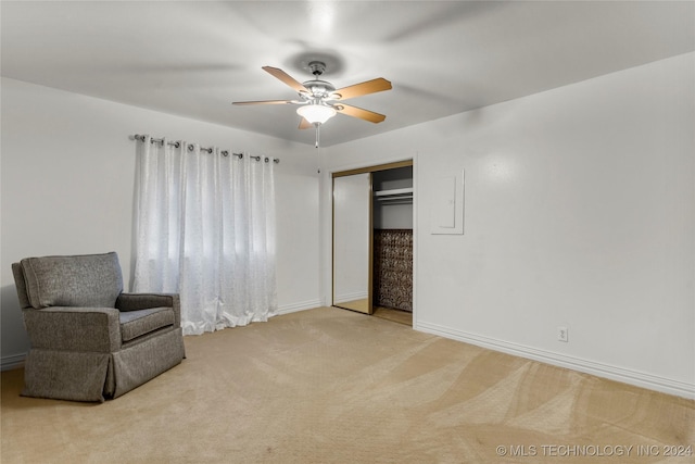 living area featuring ceiling fan and light carpet