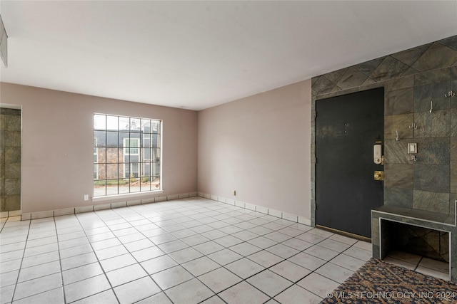 unfurnished living room featuring light tile patterned floors