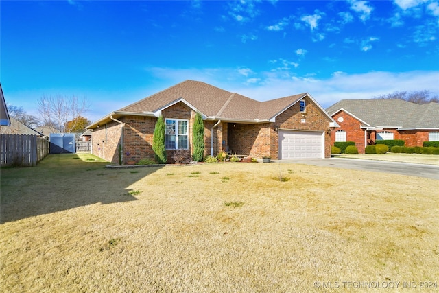 view of front of property featuring a garage and a front lawn