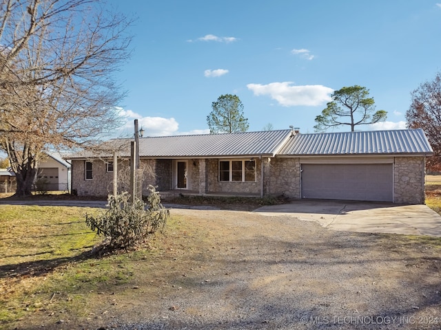 ranch-style home with a garage and a front yard