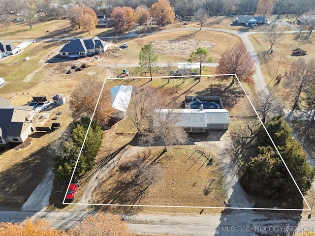 birds eye view of property with a rural view