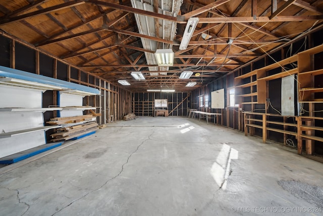 misc room featuring concrete flooring and vaulted ceiling