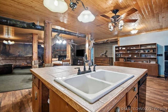 kitchen with dishwasher, sink, dark hardwood / wood-style flooring, tile countertops, and wood ceiling