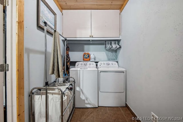 laundry room featuring cabinets, wooden ceiling, and washing machine and clothes dryer