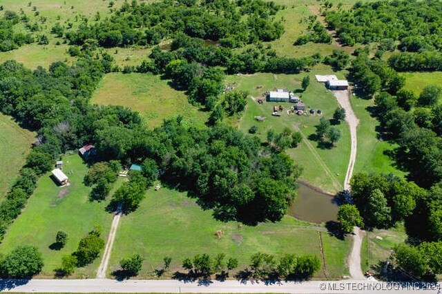 birds eye view of property featuring a water view and a rural view