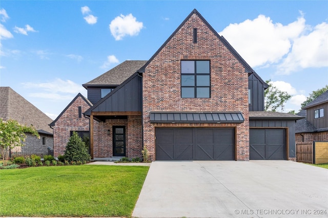 view of front of property featuring a garage and a front yard