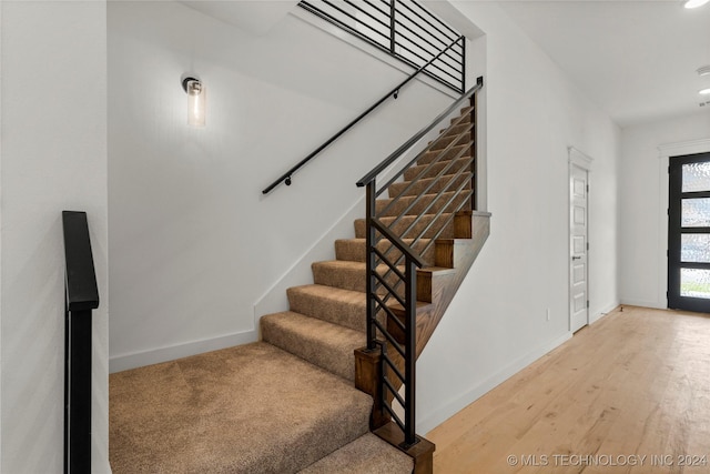 staircase featuring hardwood / wood-style floors