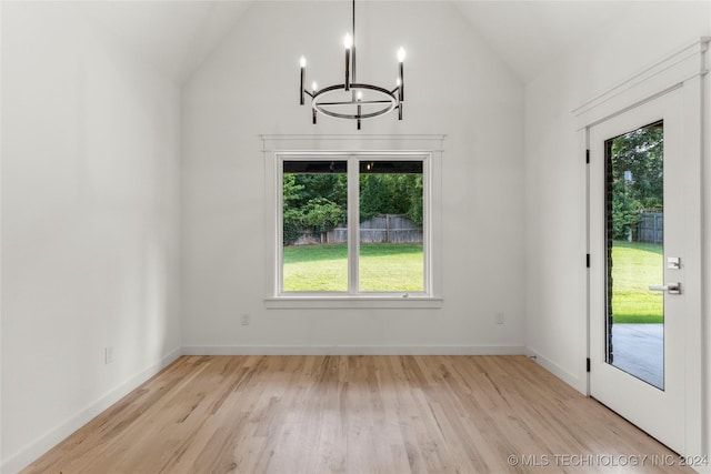 unfurnished dining area with light hardwood / wood-style floors, vaulted ceiling, and plenty of natural light