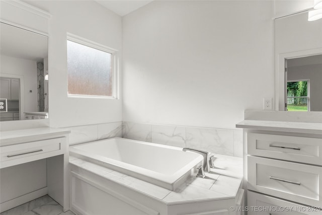 bathroom with vanity and a bathtub